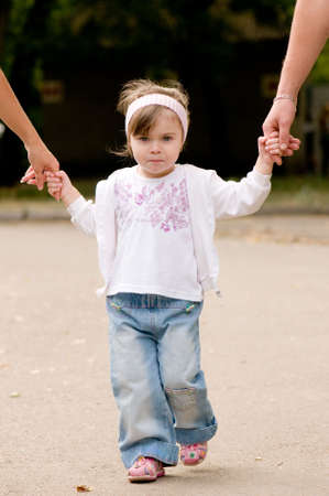 Daughter holds the hands of the father and motherの写真素材