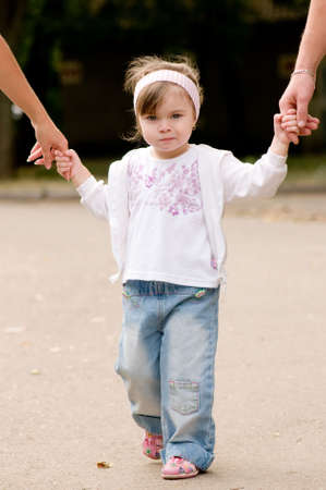 Daughter holds the hands of the father and motherの写真素材