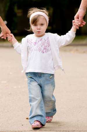 Daughter holds the hands of the father and motherの写真素材