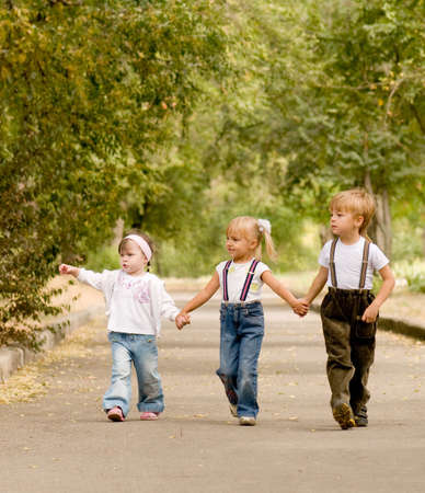 Three young friends go for a walk the parkの写真素材