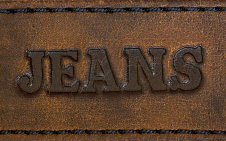 The word "jeans" is written on an old genuine leatherの写真素材