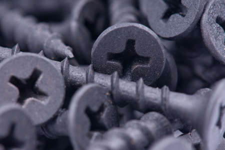 Close-up of black screws as technology backgroundの写真素材