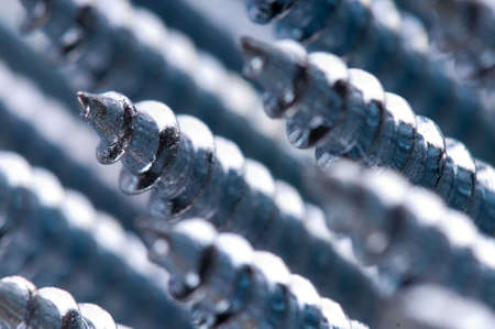 Close-up of silver screws as technology backgroundの写真素材