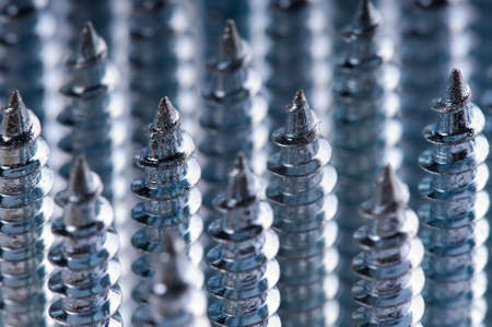 Close-up of silver screws as technology backgroundの写真素材