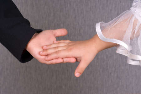 Close-up of a little boy holding girl's handの写真素材