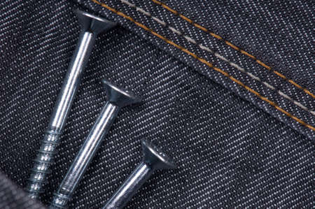 Denim fabric and screws ideal for background, close-up of jeansの写真素材