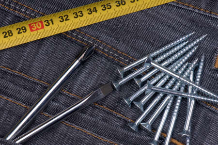 Denim fabric and screws ideal for background, close-up of jeansの写真素材