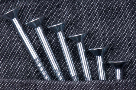 Denim fabric and screws ideal for background, close-up of jeansの写真素材