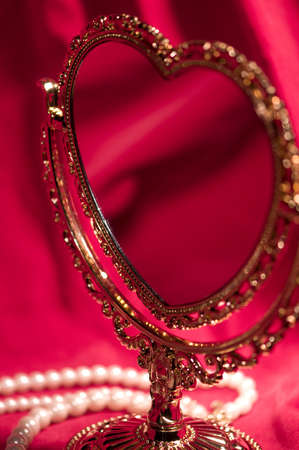 Mirror in the form of heart, pearly necklace. Valentine's day card.の写真素材