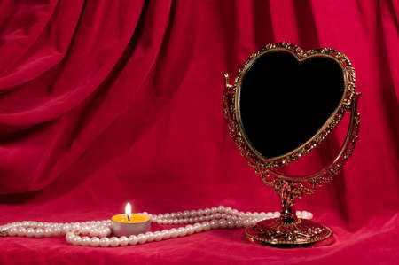 Mirror in the form of heart, pearly necklace, light. Valentine's day card.の写真素材