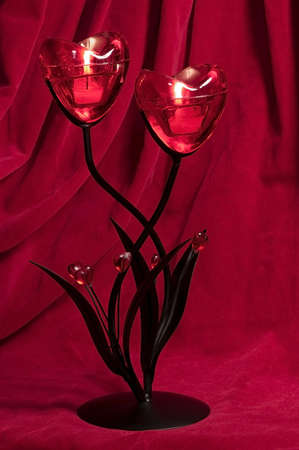 Candlestick in the form of heart, is burning on fireの写真素材