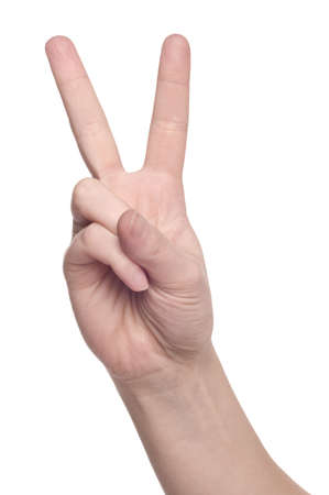 Woman hand making sign Victory isolated on white backgroundの写真素材