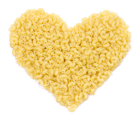 Italian pasta in the form of heart over white. Italian food background for Valentine's Day.の写真素材