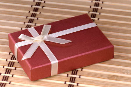 One red gift box with white ribbon and bowの写真素材
