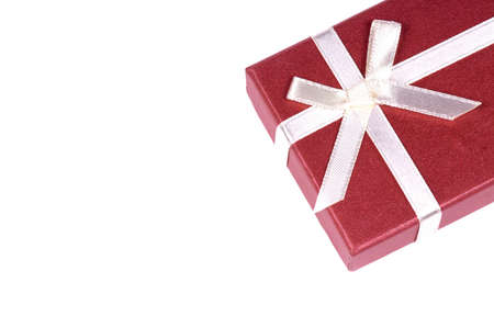 One red gift box with white ribbon and bow and isolatedの写真素材