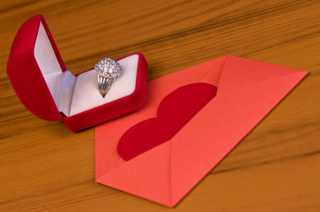 Blank Valentines Day card on table, envelope with heart and red gift boxの写真素材
