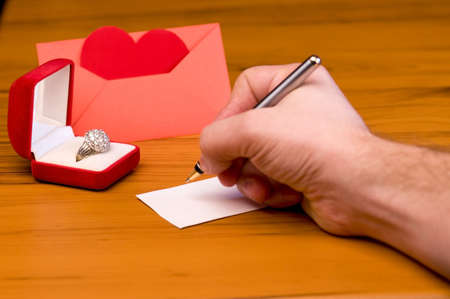 Blank Valentines Day card on table, envelope with heart, shallow depth of field with focus on the red gift box の写真素材