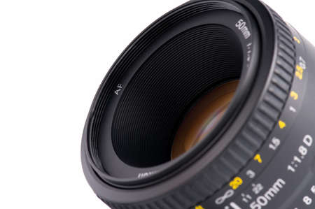 Close-up of camera lens. A basic 50mm SLR DSLR lens. Isolated on white background.の写真素材