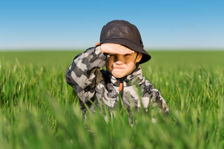 Little boy in field a bright spring's dayの写真素材