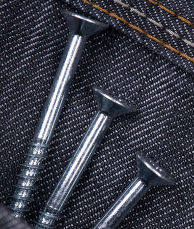 Denim fabric and screws ideal for background, close-up of jeansの写真素材