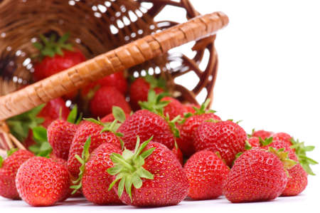 Ripe strawberry in wicker basketbasket isolated on a white backgroundの写真素材