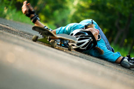 Beautiful teenage girl with skateboard in the green parkの写真素材