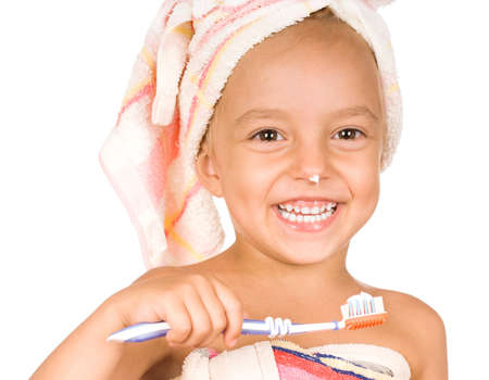 Happy little girl with toothbrush. Beautiful caucasian model. Isolated on white background.の写真素材