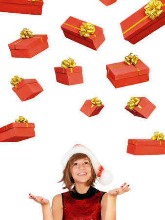 Smiling christmas girl catch gifts wearing Santa hat. Isolated on white background.の写真素材