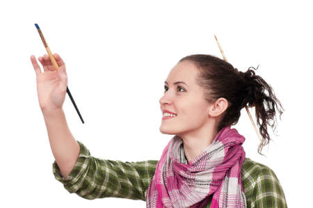 Beautiful girl with paint brush isolated over white backgroundの写真素材