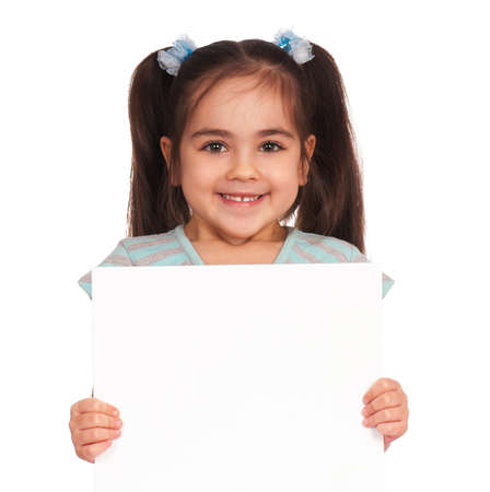 Smiling little girl holding empty white boardの写真素材