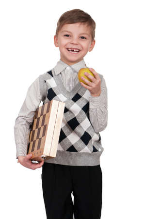 Little boy with chessboard and apple. Isolated on white background.の写真素材
