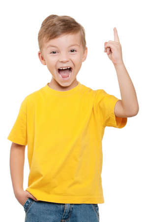 Cheerful little boy pointing up over white backgroundの写真素材