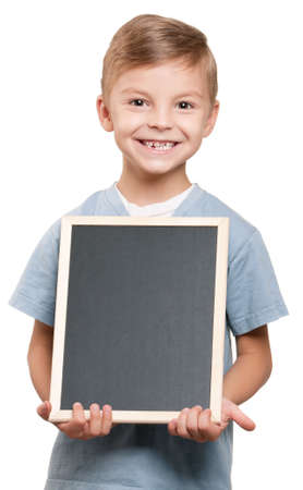 Portrait of a little boy holding a blackboard over white backgroundの写真素材