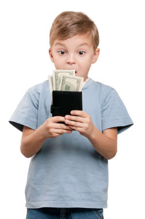 Portrait of a surprised little boy holding a dollars over white backgroundの写真素材
