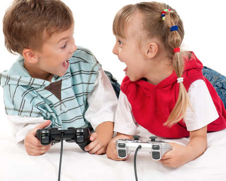 Happy children - girl and boy playing a video gameの写真素材