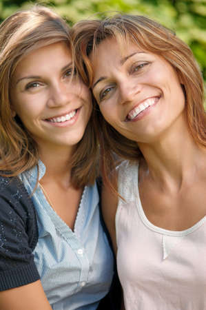 Happy mother with her daughter in park outdoorsの写真素材