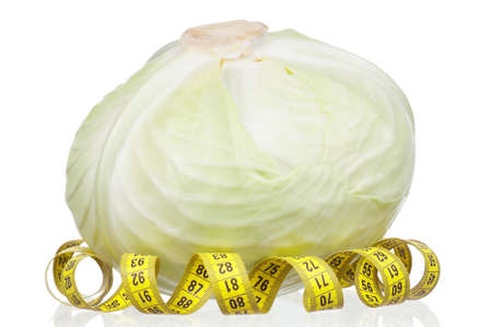 Fresh green cabbage vegetable with measure tape on white backgroundの写真素材
