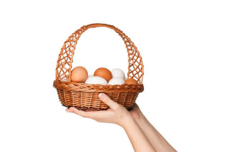 Basket with eggs in woman hand isolated on white backgroundの写真素材
