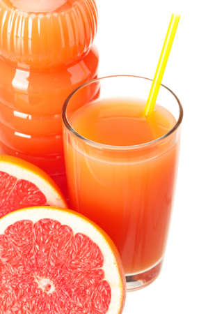 Grapefruit juice in plastic bottle and grapefruit fruits on white backgroundの写真素材
