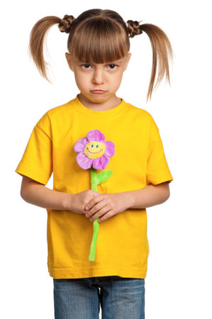 Portrait of little girl with flower isolated on white backgroundの写真素材