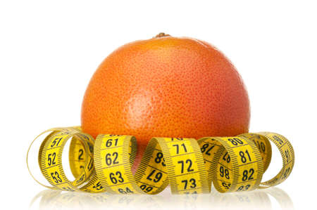 Fresh ripe grapefruit with measure tape on white backgroundの写真素材
