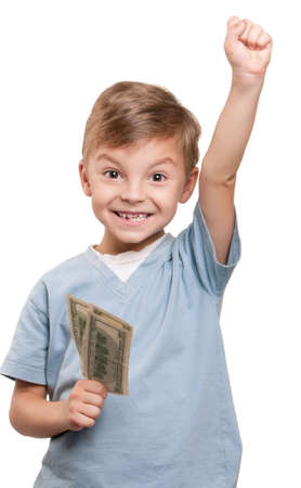 Portrait of a cheerful little boy holding a dollars over white backgroundの写真素材