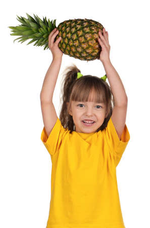 Portrait of happy little girl with pineapple over white backgroundの写真素材