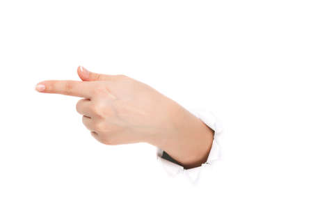Woman hand making sign through a hole in paper isolated on white backgroundの写真素材