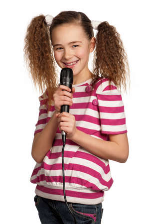 Portrait of girl singing with microphone isolated on white backgroundの写真素材