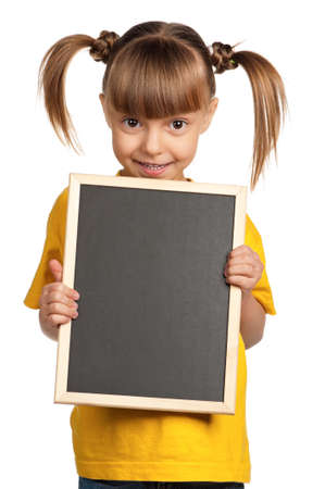 Portrait of little girl with blackboard isolated on white backgroundの写真素材