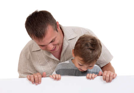 Portrait of happy dad and son with empty white board isolated on white backgroundの写真素材