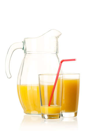 Jug and glass of fresh orange juice on white backgroundの写真素材