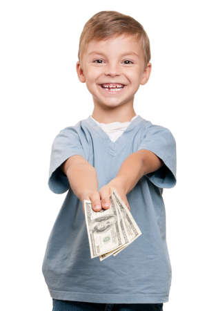 Portrait of a cheerful little boy holding a dollars over white backgroundの写真素材