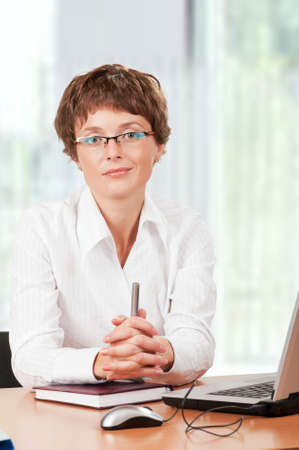 Beautiful  businesswoman working with laptop at her officeの写真素材